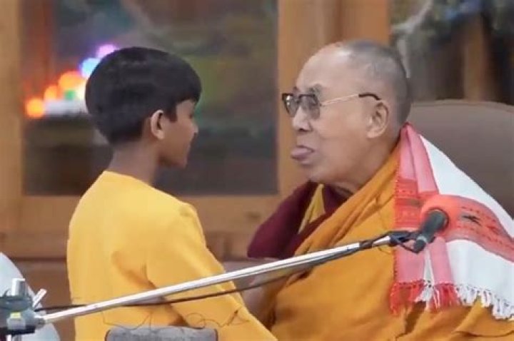 
Dalai Lama apologizes after kissing young boy on the lips, telling him to suck his tongue 